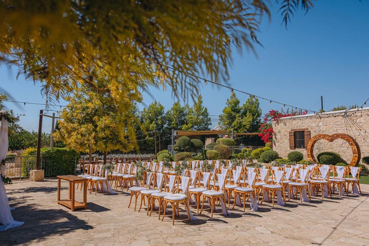 Ceremony chairs and floral heart arch at Liopetro